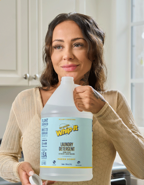 Woman holding Whip-It fresh laundry detergent